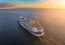 A cruise ship sailing on calm waters during sunset