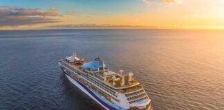 A cruise ship sailing on calm waters during sunset