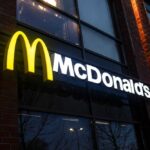 McDonald’s Admits Big Change Underway Illuminated McDonald's sign on a brick building at night