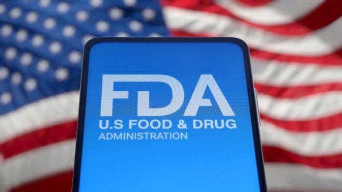 shutterstock_2593162175.jpg FDA logo displayed on a smartphone with an American flag background