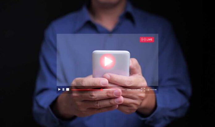 Person holding a smartphone with a live streaming interface