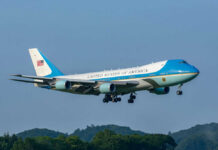VIDEO: Foreign Gift Flies As Air Force One Airplane flying above trees with blue sky background