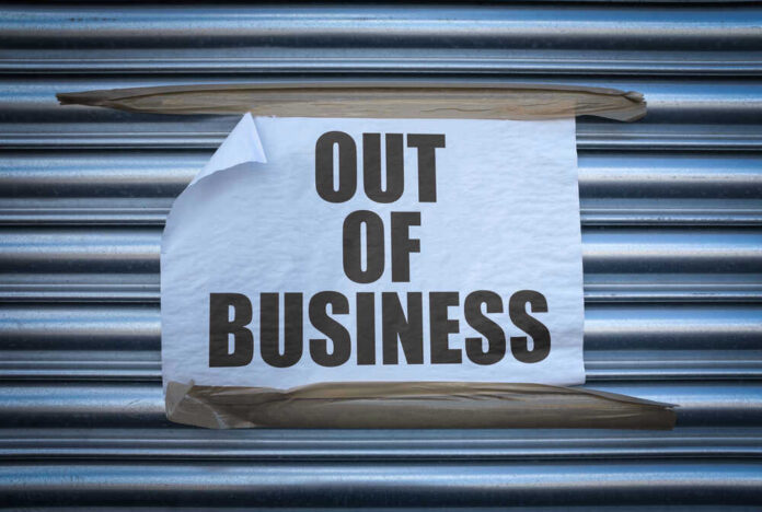 shutterstock_1839764254 Out of Business sign on closed store shutters.