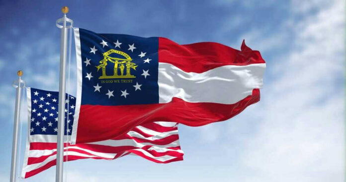 shutterstock_2144966627 Georgia state flag and U.S. flags waving together.