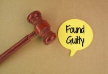 A wooden gavel next to a yellow speech bubble that says 'Found Guilty'