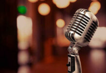 Vintage microphone on a blurred, warm-toned background.