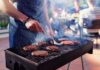 Backyard BBQ Shock Hits U.S. Person grilling burgers at an outdoor barbecue