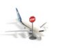 War Fuel Shock Hits U.S. Flights – Routes Canceled A toy airplane next to a stop sign