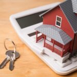 Mortgage Shock: THIS Status Enters Risk Math A miniature red house on a calculator with keys nearby