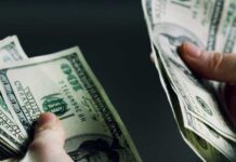 Running On Fumes: Savings Hit Hard Hands holding and counting stacks of cash