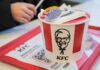 Chicken Wars: KFC Goes All-In KFC restaurant sign against a blue sky