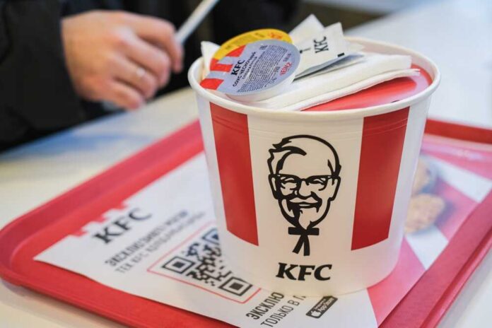 Uralsk,,Kazakhstan,-,December,10,,2025:,Kfc,Bucket,With,Strips. KFC restaurant sign against a blue sky