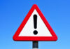 VIDEO: Deadly Sky Horror Kills 6 A triangular warning sign with an exclamation mark against a blue sky