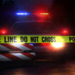 6 Gunned Down As Soft-On-Crime Failure Explodes Police car with flashing lights behind caution tape.