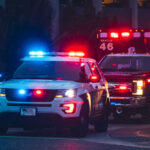 NFL Coach’s Son, Gunfire, Horrible Crime Police car and ambulance with flashing lights nighttime