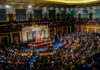 Full chamber meeting with numerous attendees and speakers.