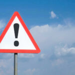 VIDEO: Mall Collapse Sparks Panic, Chaos Triangle warning sign with exclamation mark against sky.