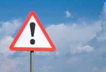 VIDEO: Mall Collapse Sparks Panic, Chaos Triangle warning sign with exclamation mark against sky.