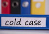 Cold Case Blood Drop Points to Friend Blue binder labeled 'cold case' with other colored binders in the background