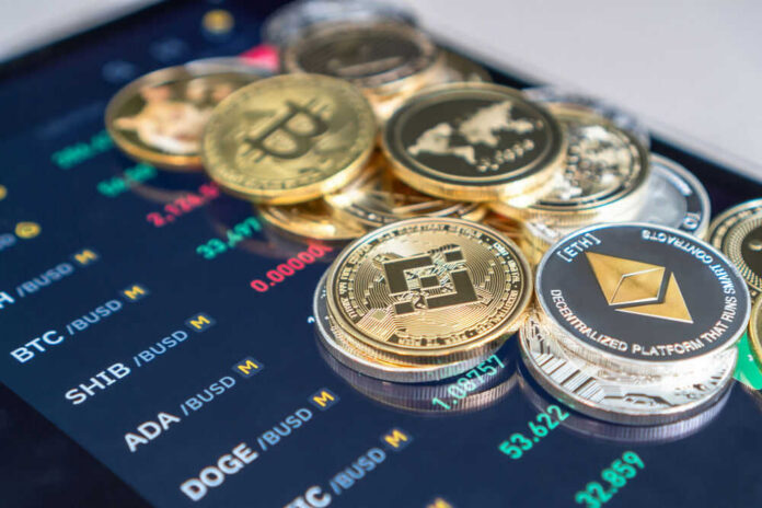 shutterstock_2002007354 Cryptocurrency coins on digital trading screen