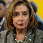 Pelosi Admits Crash — Drives Off Nancy Pelosi wearing plaid blazer at event.