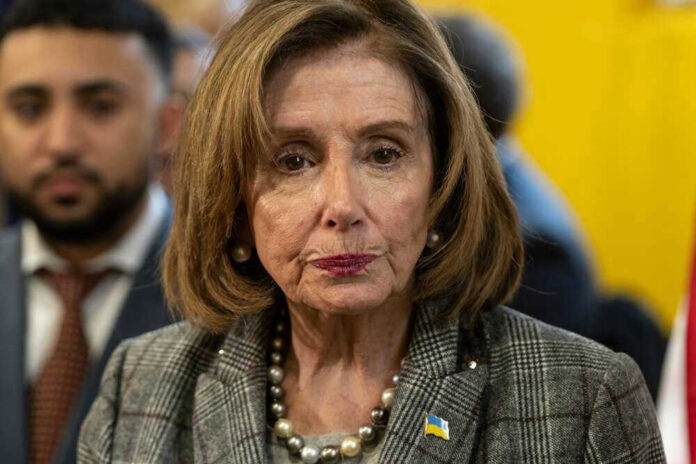 shutterstock_2135602043 Nancy Pelosi wearing plaid blazer at event.