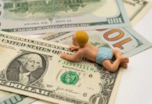 Dell’s $6.25B Power Play For KIds Announced A baby figurine crawling on top of various dollar bills