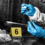 Buried Under Garage: A 1936 Murder Reawakens Forensic investigator collecting a blood sample at a crime scene