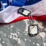 American Blood Spilled, Immediate Payback Military dog tags on camouflage fabric with an American flag