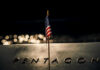 Pentagon Admits Alarming Troop Toll American flag above engraved Pentagon sign at night
