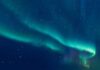 Cosmic Sugar Stuns Astronomers A vibrant display of the northern lights in a starry night sky