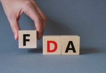 FDA’s HIGHEST Alert Hits Beloved Snack Food A hand holding a wooden block with the letter F, next to blocks spelling FDA