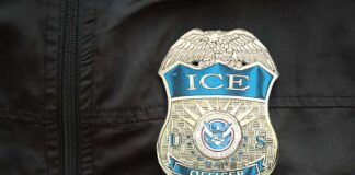 Close-up of an ICE officer badge on a black jacket
