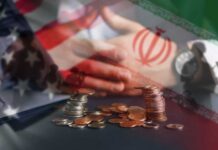 Iran War Destroying THESE U.S. Farms A hand resting on a table with coins stacked in front, overlaid with flags of the US and Iran