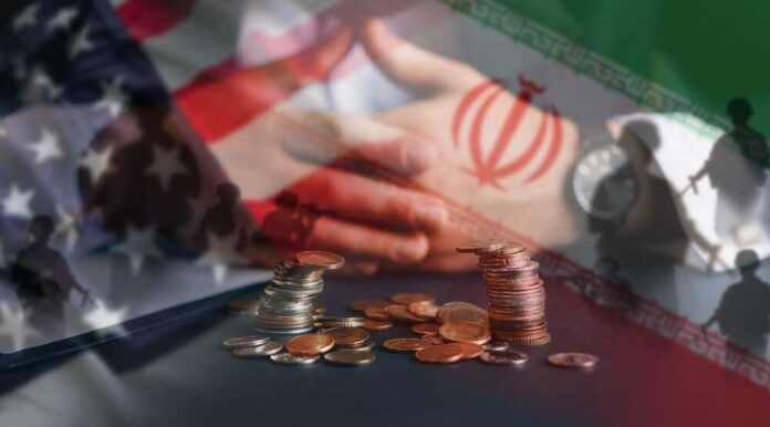 Terrible,War,Between,Us,And,Iran.us,Vs,Iran.iran,And,United A hand resting on a table with coins stacked in front, overlaid with flags of the US and Iran
