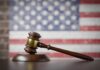 Court Majority Rebuffs Trump on Crucial Immigration Issue A wooden gavel resting on a sound block with an American flag background