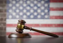 Court Majority Rebuffs Trump on Crucial Immigration Issue A wooden gavel resting on a sound block with an American flag background