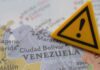 Death Toll Grows More Shocking in Venezuela A close-up of a map of Venezuela with a yellow warning sign