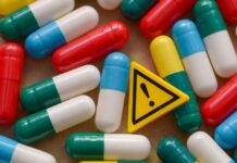 Medicare Shock: 2027 Cushion Vanishes Colorful capsules scattered around a yellow warning sign