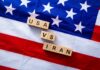 Iran Barrage Stopped — Then Things Escalated Wood letter blocks on an American flag