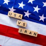 Iran Barrage Stopped — Then Things Escalated Wood letter blocks on an American flag