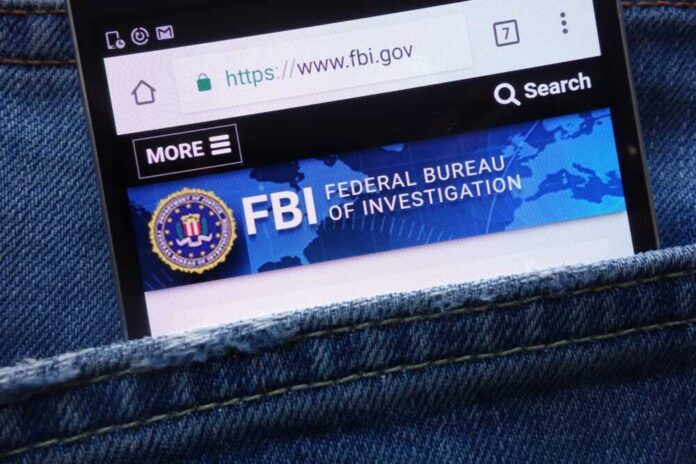 shutterstock_1099317668 Mobile phone displaying the FBI website in a denim pocket