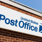 United States Post Office sign on a brick building