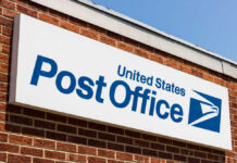 United States Post Office sign on a brick building