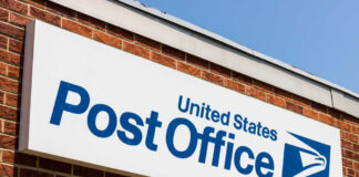 United States Post Office sign on a brick building