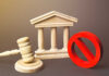 Wooden courthouse with a gavel and red prohibition symbol