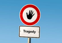 VIDEO: 23 Dead – Highway Horror Road sign with hand stop symbol and a lower sign reading Tragedy