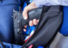 School Bloodbath Stuns Nation A hand holding a gun inside a backpack