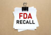 Walmart Soup Triggers 29-State Scare A notice labeled 'FDA RECALL' clipped to white papers on a brown background