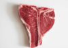 Raw T-bone steak on a white background